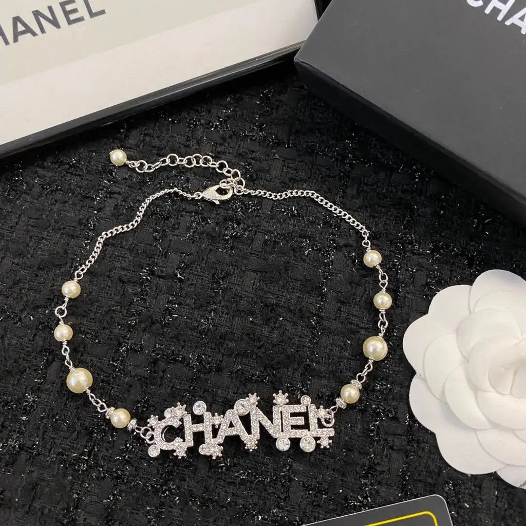 Chanel Jewelry | Pearl Strand with Integrated Crystal-Encrusted Logo